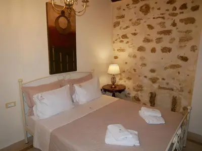 a bedroom with a bed with two towels on it at Christina's Villa with sea view in Daratso