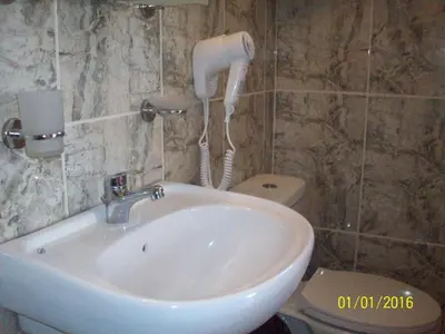 a bathroom with a sink and a phone on the wall at Posto Studio 5 Chania Crete 100 m from the beach in Daratso