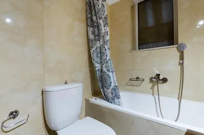 a bathroom with a toilet and a bath tub at Ferenikis apartment in Chania Town