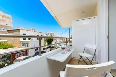 a balcony with a table and two glasses of wine at Ferenikis apartment in Chania Town