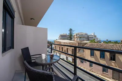 a balcony with a table and chairs and a view at Halepa Apartment's in Chania in Chania Town