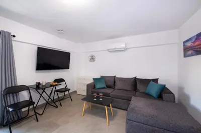 a living room with a couch and a table at Halepa Apartment's in Chania in Chania Town