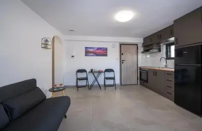 a kitchen and living room with a couch and a table at Halepa Apartment's in Chania in Chania Town
