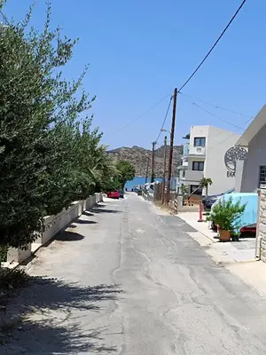 an empty street with trees on the side of a building at Sandy Suite 3 in Agia Marina Nea Kydonias