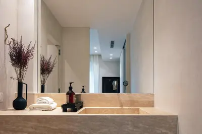 a bathroom with a sink and a mirror at Sea Path I Chania City Center luxury Suites in Chania Town