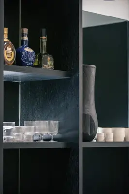 a shelf with bottles and a vase on it at Sea Path I Chania City Center luxury Suites in Chania Town