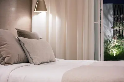 a bedroom with a bed with pillows and a window at Sea Path II Chania city Center luxury Suites in Chania Town