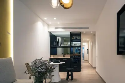 a kitchen with black cabinets and a table at Sea Path II Chania city Center luxury Suites in Chania Town