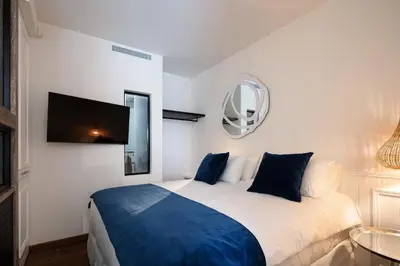 a bedroom with a large bed and a mirror at Sea Path III Chania city Center luxury Suites in Chania Town