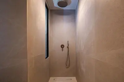 a bathroom with a shower with a shower head at Sea Path III Chania city Center luxury Suites in Chania Town