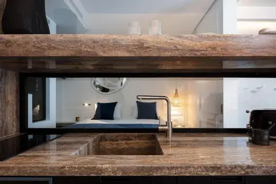 a bathroom with a sink and a bed in a room at Sea Path III Chania city Center luxury Suites in Chania Town