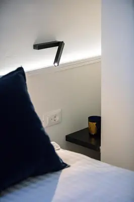 a bedroom with a bed with a black light above it at Sea Path IV Chania city center luxury Appartment in Chania Town
