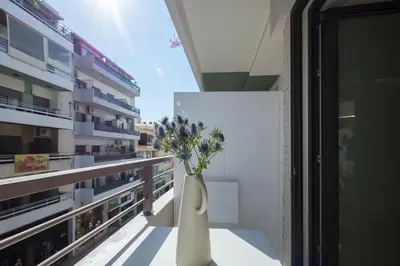 a vase with flowers sitting on top of a balcony at Sea Path IV Chania city center luxury Appartment in Chania Town