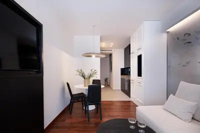 a living room with a white couch and a table at Sea Path IV Chania city center luxury Appartment in Chania Town
