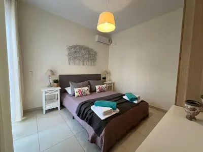 a bedroom with a large bed in a room at Colibri seafront villa with pool in Nopíyia