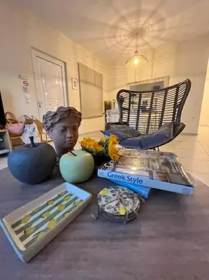 a table with a statue of a boy and some food at Colibri seafront villa with pool in Nopíyia