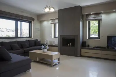a living room with a couch and a fireplace at Villa-Azalea in Almirida