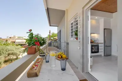 a balcony with a table with fruit on it at Maestro House in Chania Town