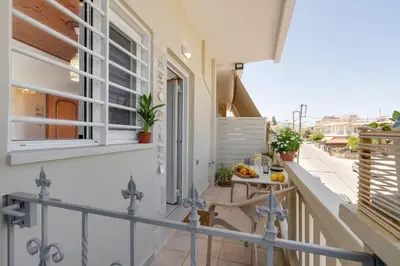 a balcony with a table and a window at Maestro House in Chania Town