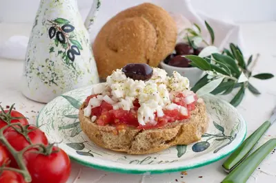 a plate with a sandwich with red sauce and vegetables at Proimos Maisonnettes in Plataniás