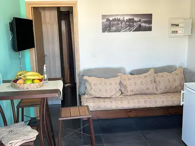 a living room with a couch and a table at Marias Apartment in Chania Town