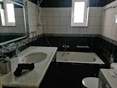 a bathroom with a sink and a bath tub at Sonema Seaside Apt in Chania Town
