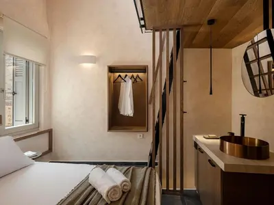 a bedroom with a bed and a bathroom with a sink at Monk Residence 27 - next to old Venetian Harbor in Chania Town