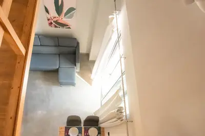 a staircase in a house with a blue couch at Filitsa's Luxury House in Chania Town