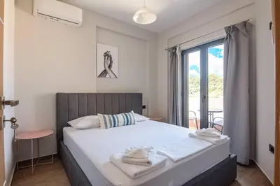 a bedroom with a large bed and a window at Filitsa's Luxury House in Chania Town