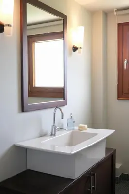 a bathroom with a white sink and a mirror at Fleur du sud - Villa in Chania in Korakiaí