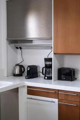 a kitchen with a counter with a microwave and appliances at Fleur du sud - Villa in Chania in Korakiaí