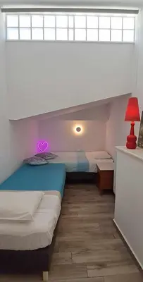 a bedroom with a bed with a purple heart on it at MariAdni Garden House in Kissamos
