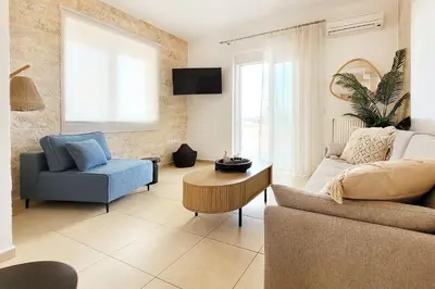 a living room with a couch and a chair at Everlane Seaview Villa in Arménoi