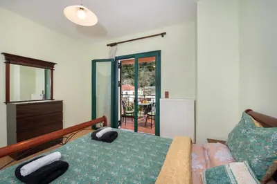 a bedroom with a bed and a couch and a window at Jacuzzi Villa Nena in Thérison