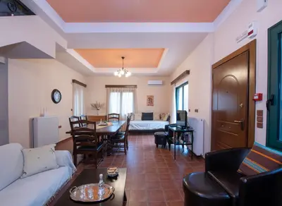 a living room with a couch and a table at Jacuzzi Villa Nena in Thérison