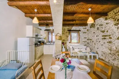 a kitchen and dining room with a table and chairs at Nature stone retreat between Balos & Elafonisi beach, contactless check-in, Mouri Nature House in Mouríon