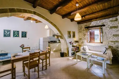 a living room with a table and a couch at Nature stone retreat between Balos & Elafonisi beach, contactless check-in, Mouri Nature House in Mouríon