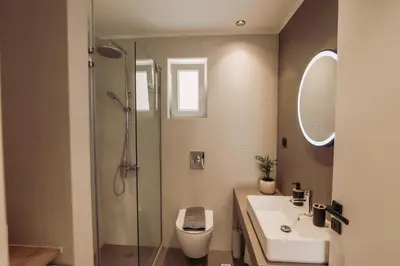 a bathroom with a toilet and a sink and a shower at Cozy Living Apartments Chania close to the beach in Chania Town