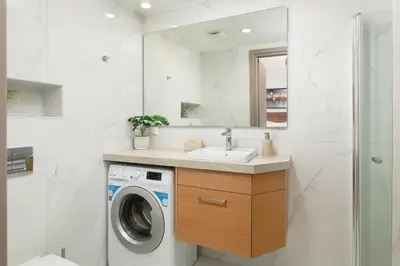 a bathroom with a washing machine and a sink at The Sandgate Elegant studio, Chania Seaside in Chania Town
