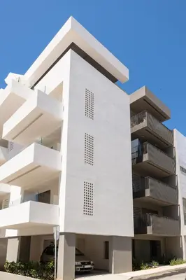 a white building with balconies on a street at The Sandgate Elegant studio, Chania Seaside in Chania Town