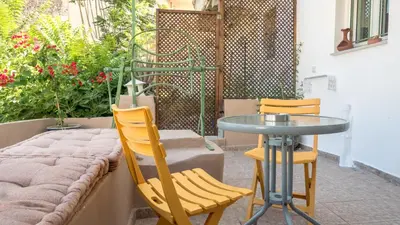 a table and two chairs sitting next to a table at Τhemis House in Chania Town