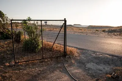 an open gate on the side of a road at Falasarna Caravans in Falasarna