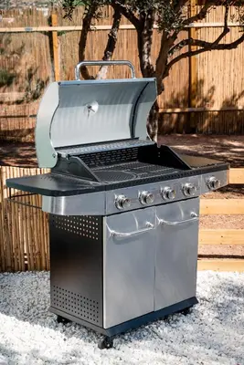 a grill sitting on the ground in a yard at Falasarna Caravans in Falasarna