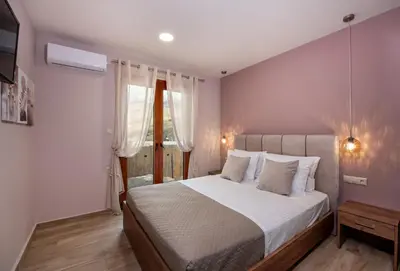 a bedroom with a large bed and a window at Iasmos in Sfakiá