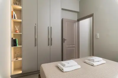 a bedroom with a bed with two towels on it at SugarDustApt Elegant Retreat 150m from the Sea in Chania Town
