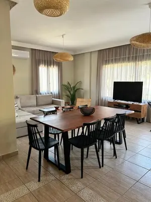 a living room with a table and chairs and a couch at VENTO villa neriana in Khainderianá