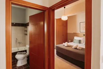 a bedroom with a bed and a bathroom with a toilet at Ibis Apartments Chania,close to the beach in Chania Town