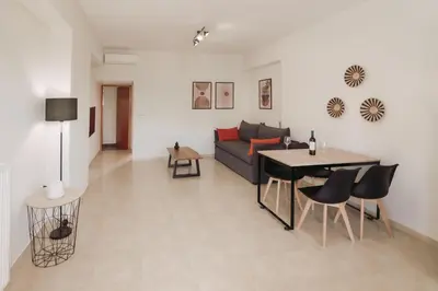a living room with a couch and a table at Ibis Apartments Chania,close to the beach in Chania Town