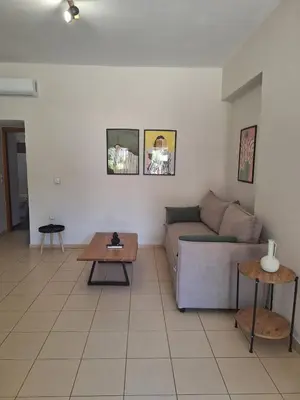 a living room with a couch and a table at Ibis Apartments Chania,close to the beach in Chania Town