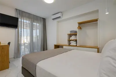 a bedroom with a bed and a large window at Theo Luxury Villas With Sea View in Agia Marina Nea Kydonias